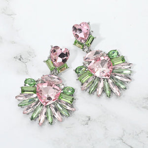 Pink and Green Heart Crystal Fan pageant and prom earrings on silver displayed on a white marble background