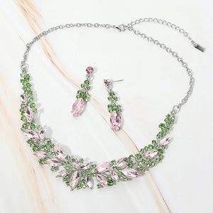 Pink and green marquise stone cluster prom and evening necklace set on silver on white marble background