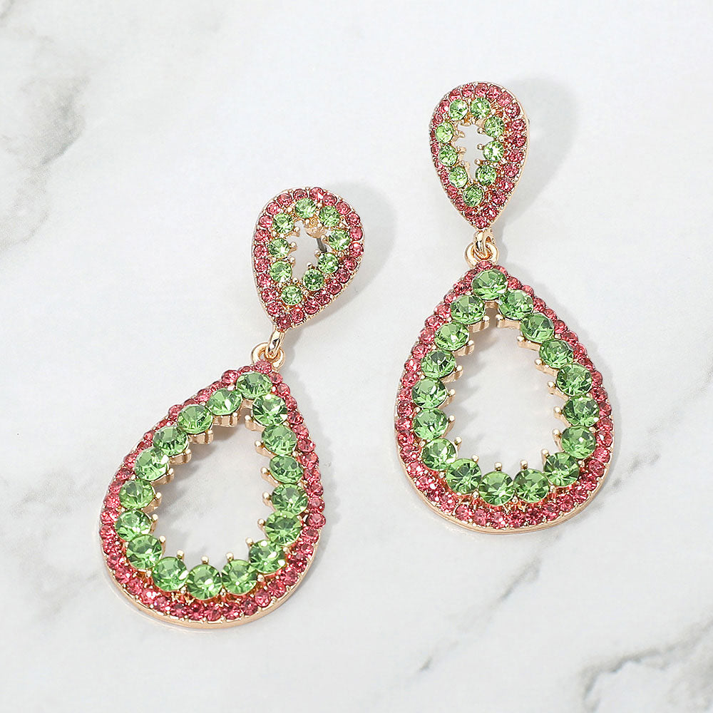 Pink and green pave open teardrop earrings on gold displayed on white marble background