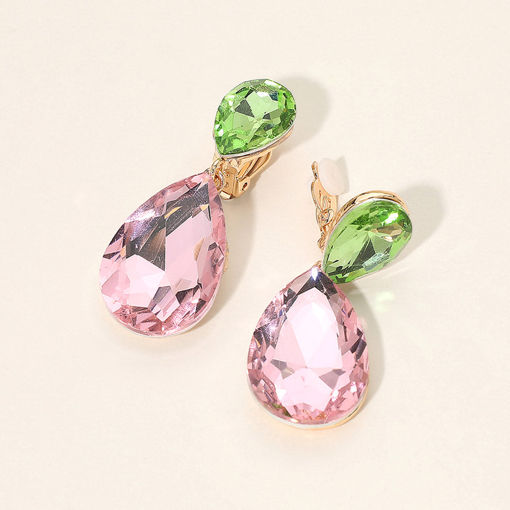 Pink and green teardrop crystal clip-on earrings on gold on white marble background