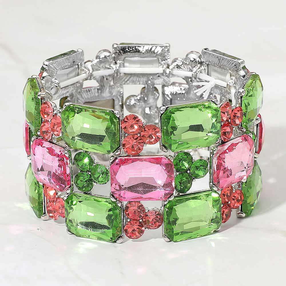 Pink and green wide emerald cut crystal stretch bracelet on silver on white background