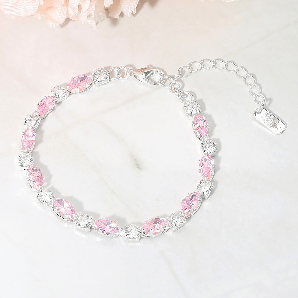 Pink marquise crystal prom bracelet on silver on white marble background