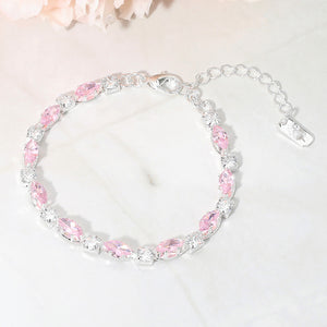 Pink marquise crystal prom bracelet on silver on white marble background