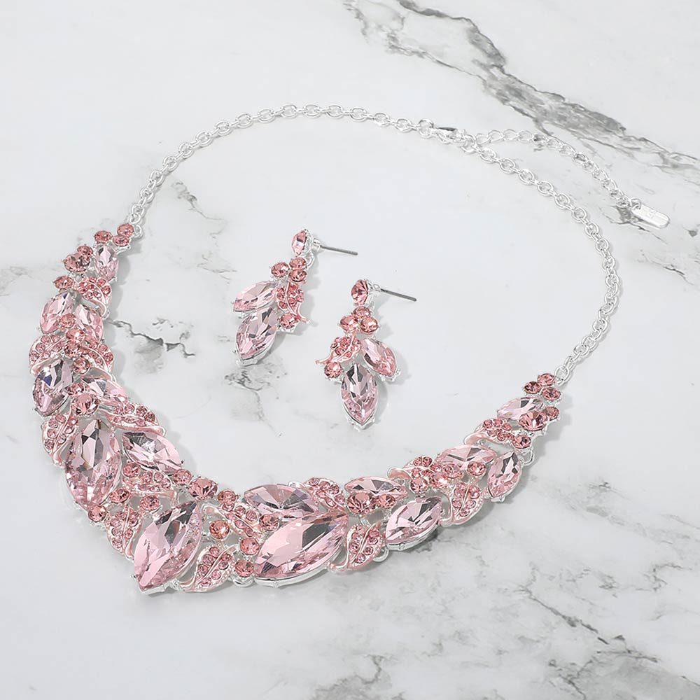 Pink marquise leaf crystal necklace set on silver with matching earrings, elegant statement jewelry for prom and evening wear on a marble background