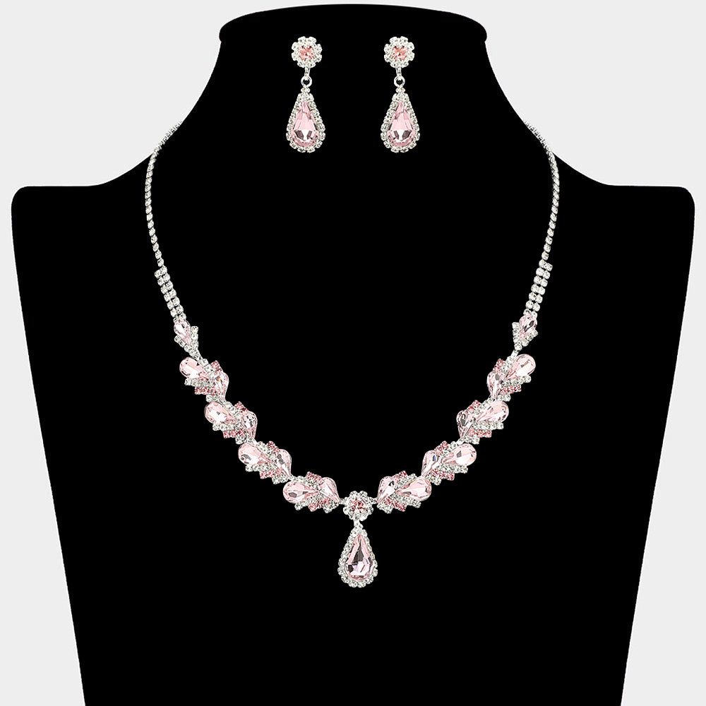 Pink marquise pendant necklace set on silver with matching earrings for prom and evening wear on a black mannequin bust on a white background.