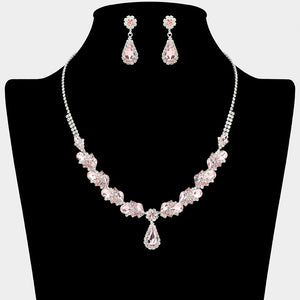 Pink marquise pendant necklace set on silver with matching earrings for prom and evening wear on a black mannequin bust on a white background.