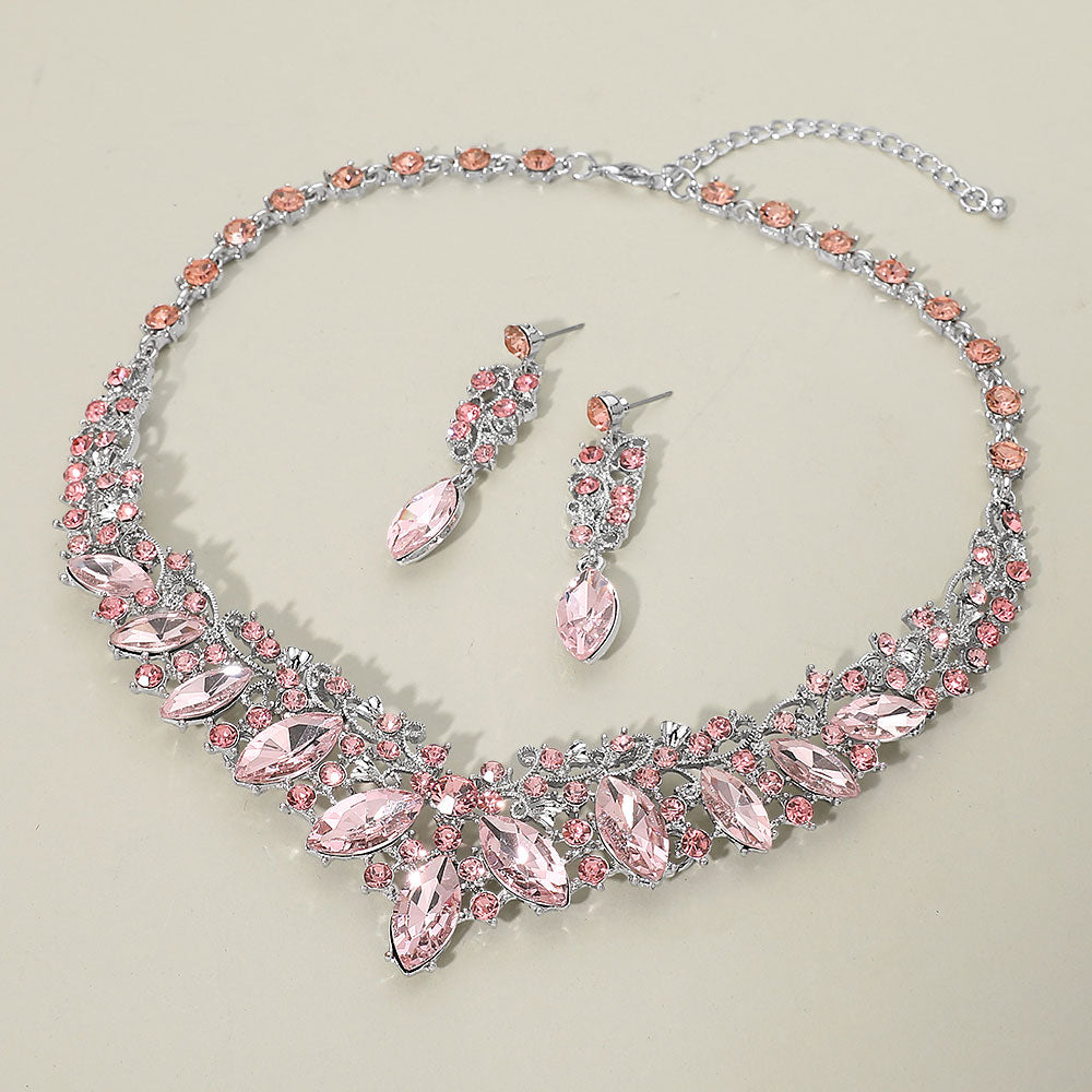 Pink marquise crystal statement necklace set on silver displayed on beige background