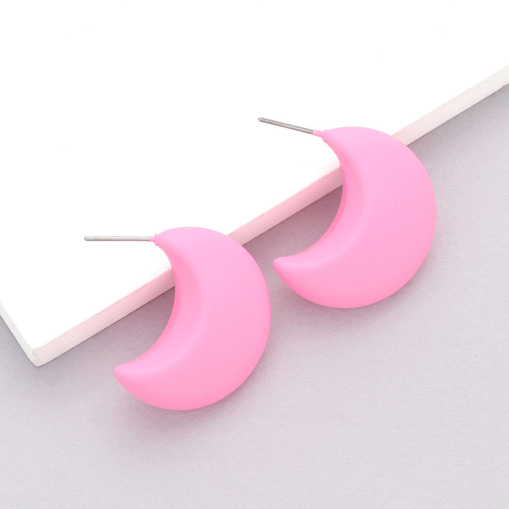 Pink matte crescent moon earrings on a white background