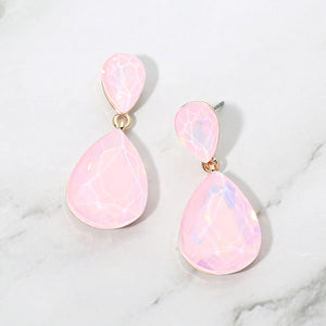 Pink opal crystal double teardrop dangle earrings on gold displayed on a white marble background.