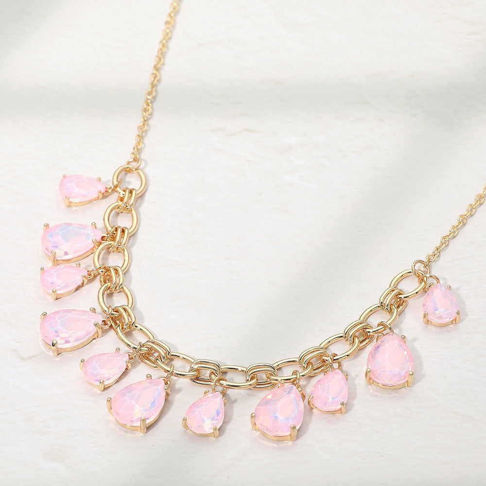 Pink opal crystal teardrop statement necklace on gold on white background