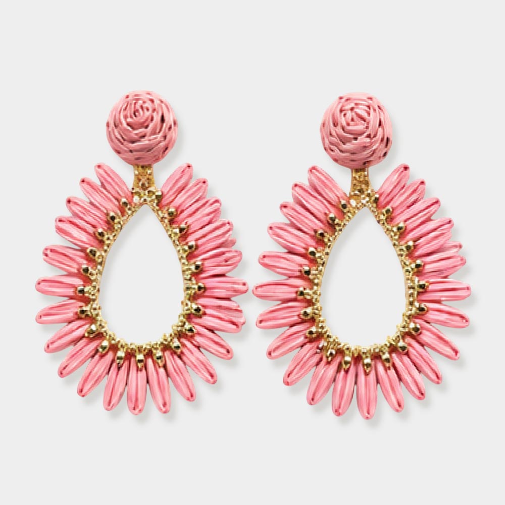 Pink woven raffia open teardrop earrings on gold with post backs isolated on a white background.