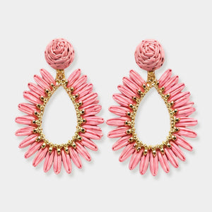 Pink woven raffia open teardrop earrings on gold with post backs isolated on a white background.