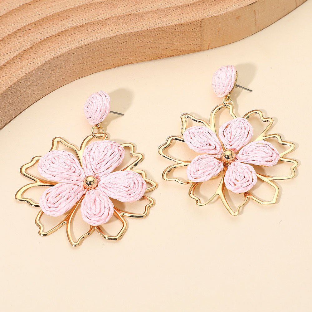 Pink raffia floral dangle earrings with layered petal design and boho statement style. Fun fashion earrings for runway, appearances, and standout looks.