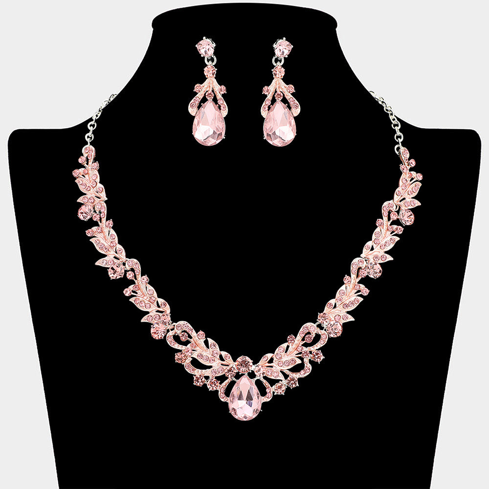 Pink crystal teardrop leaf necklace and earring set styled for prom or evening wear, shown on a black mannequin bust on a white background