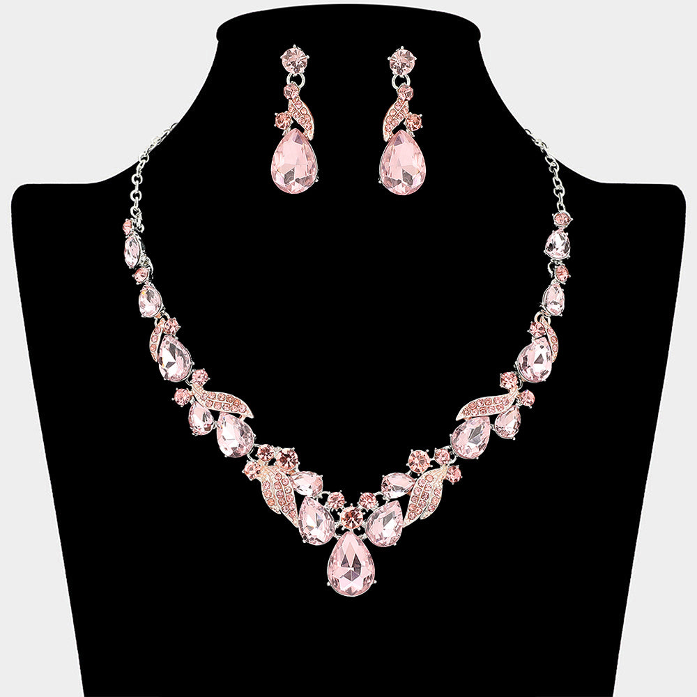Pink teardrop leaf prom necklace set on silver with matching earrings displayed on a black mannequin bust on a white background.