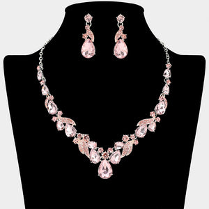 Pink teardrop leaf prom necklace set on silver with matching earrings displayed on a black mannequin bust on a white background.