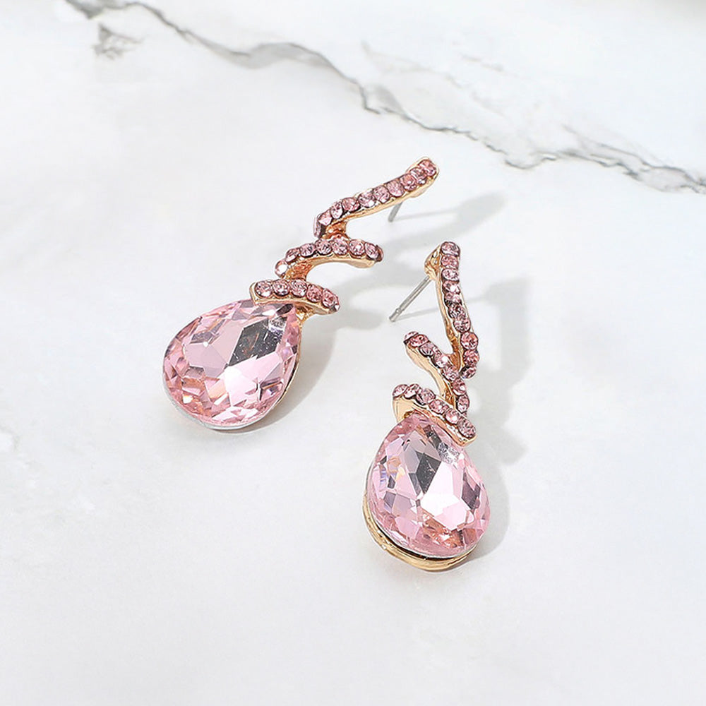 Pink teardrop swirl crystal earrings for girls pageant or flower girl style on a white background