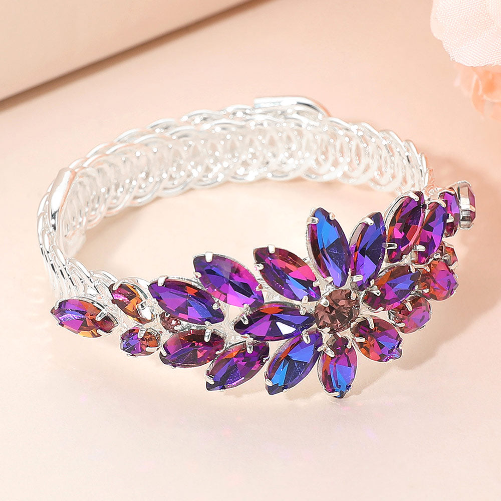 Purple Aurora Borealis crystal floral marquise adjustable bracelet on silver displayed on a beige background.