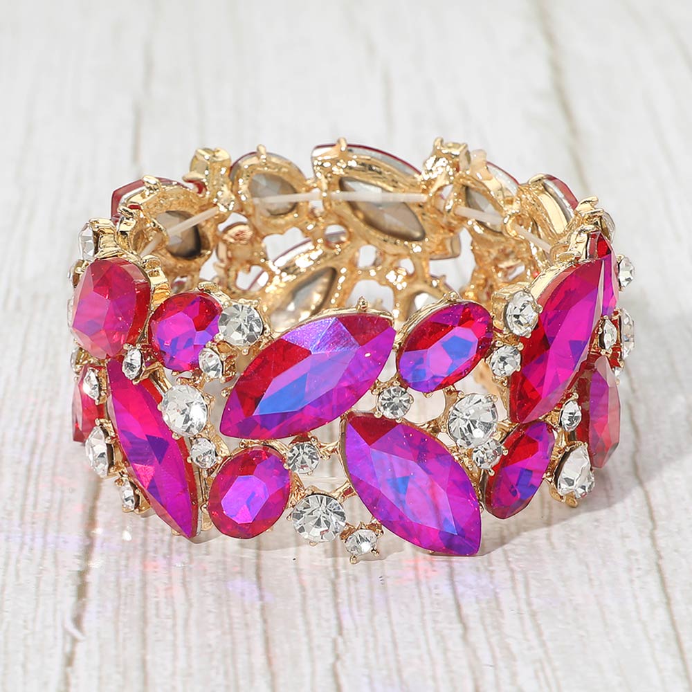 Purple AB crystal marquise stretch statement bracelet on gold on a wood grain background