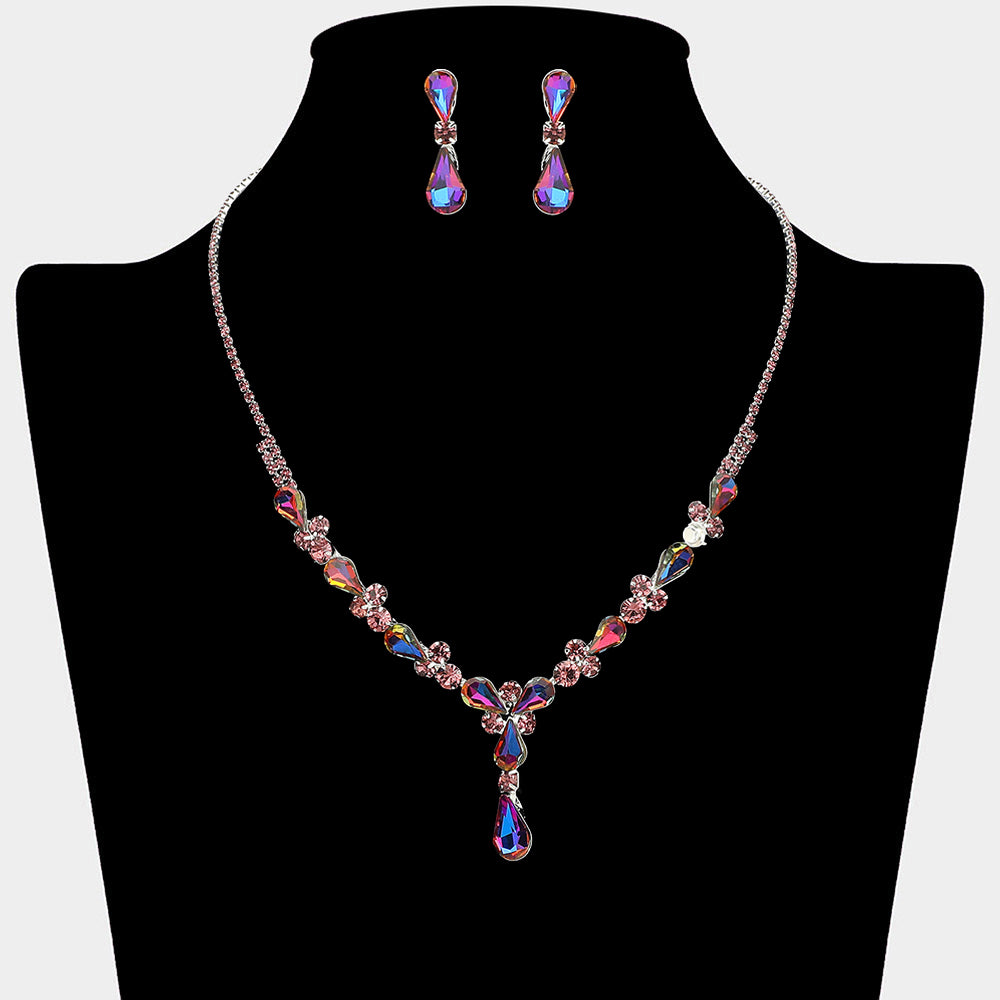 Purple teardrop crystal necklace set on silver with matching earrings for prom and evening wear on a black mannequin bust on a white background.