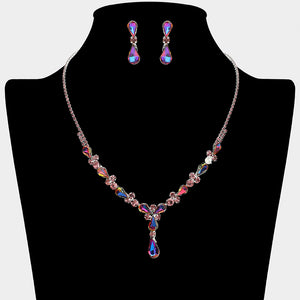 Purple teardrop crystal necklace set on silver with matching earrings for prom and evening wear on a black mannequin bust on a white background.