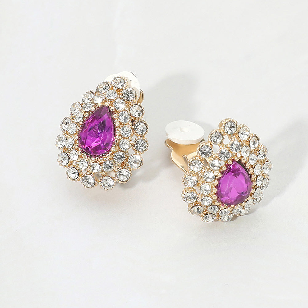 Purple teardrop rhinestone halo clip-on earrings with silver-tone setting and crystal cluster design on a light gray background