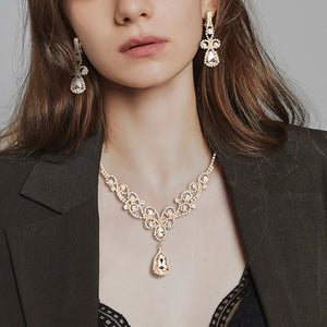 clear on gold crystal rhinestone vine necklace set worn on model with clip-on earrings