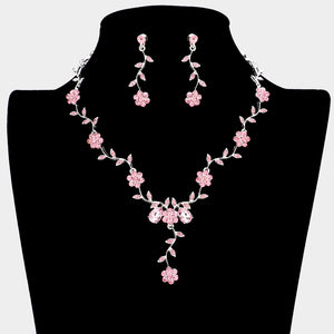 Pink crystal prom necklace set on silver with matching earrings displayed on a black mannequin bust on a white background.