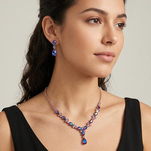 Purple teardrop crystal necklace set on silver with matching earrings for prom and evening wear shown here on a model