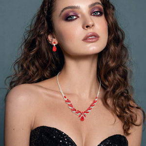 Model wearing Red teardrop marquise prom necklace set on silver with matching earrings 