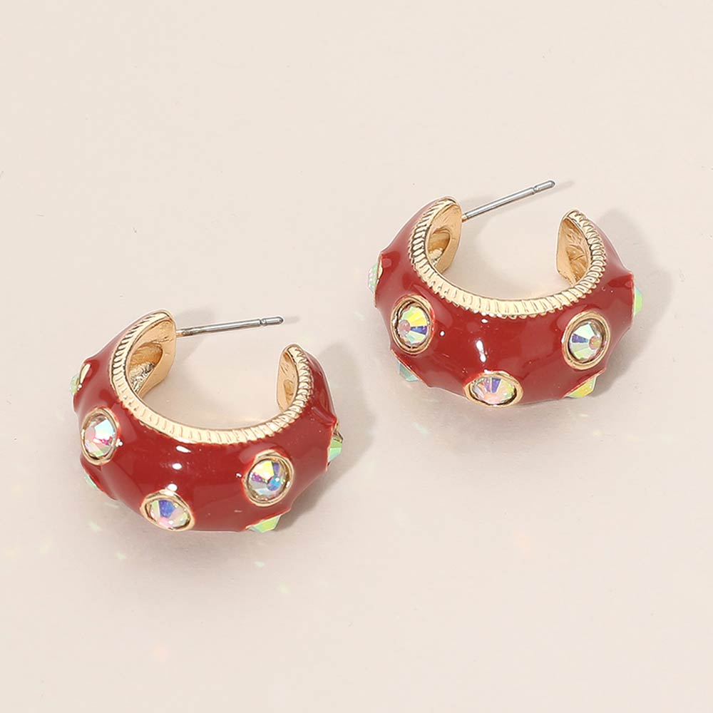 Red enamel huggie hoop earrings with AB stones 1 inch size shown on a beige background