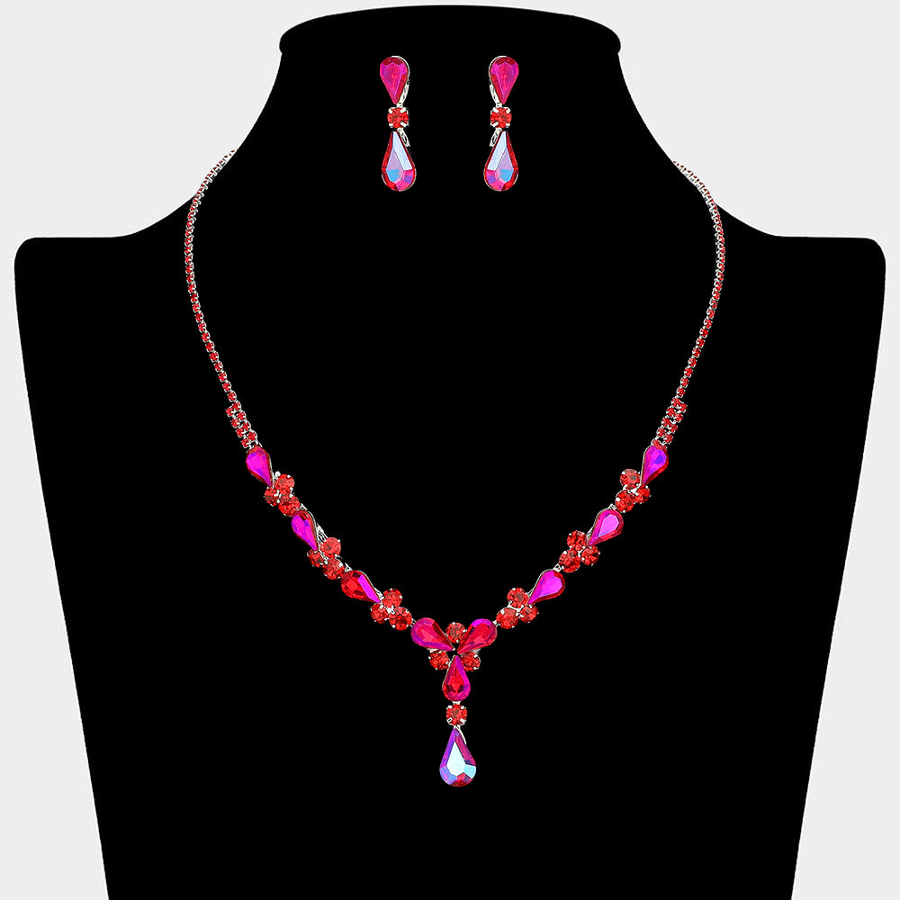 Red teardrop crystal necklace set on silver with matching earrings for prom and evening wear on a black mannequin bust on a white background.