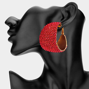 Red bling pavé crystal wide hoop earrings on gold-tone metal with dense faceted rhinestone coverage and omega backs, displayed on a black mannequin profile.
