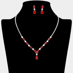 Red and clear crystal dainty necklace set on silver with spaced crystal accents, a delicate center drop, and matching drop earrings, displayed on a black jewelry bust.