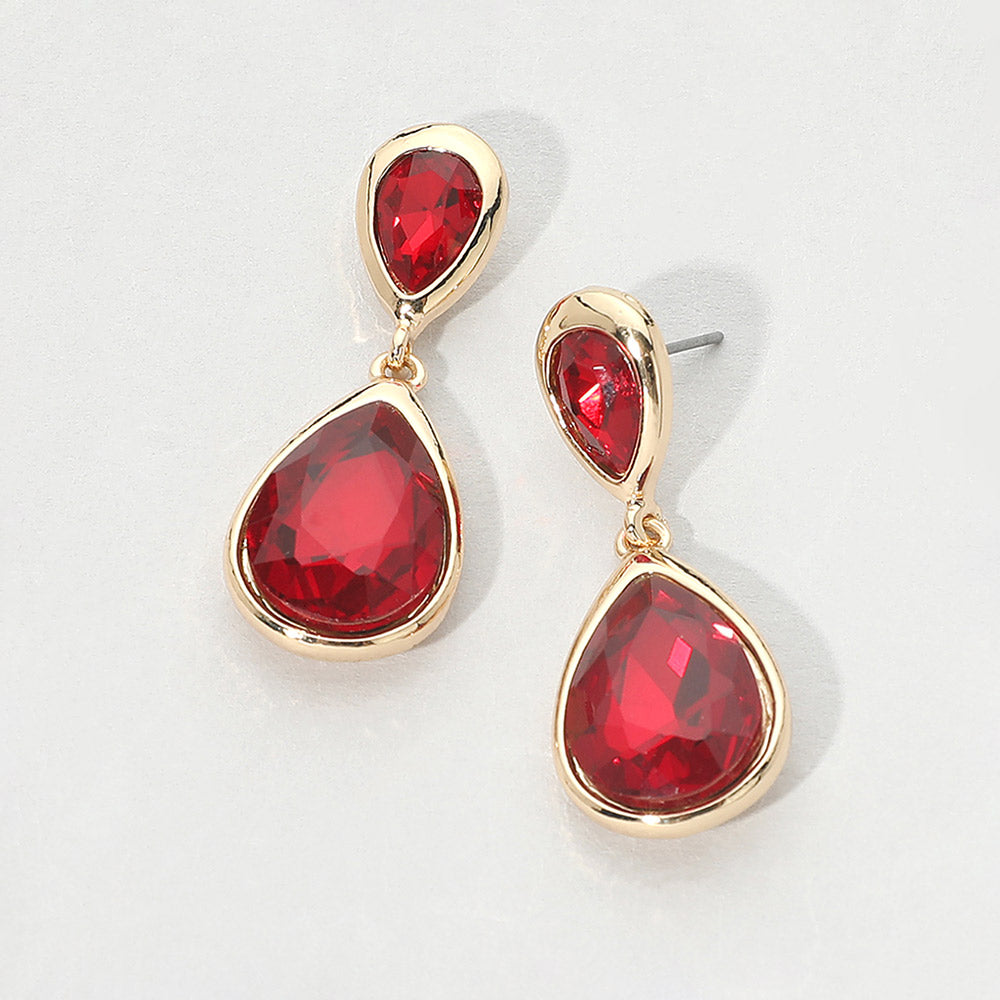 Gold-tone drop earrings with faceted red double teardrop crystals, displayed on a clean white background.