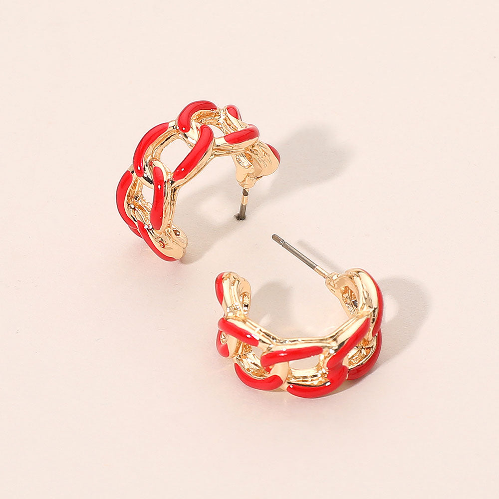 Red enamel chain hoop earrings with mini linked half-hoop design and post-back closure on a beige background