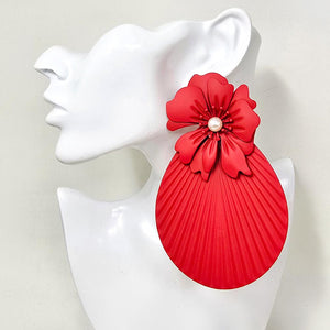 Oversized red flower fan statement earrings with layered floral tops and large pleated fan drops, displayed on a white jewelry mannequin.