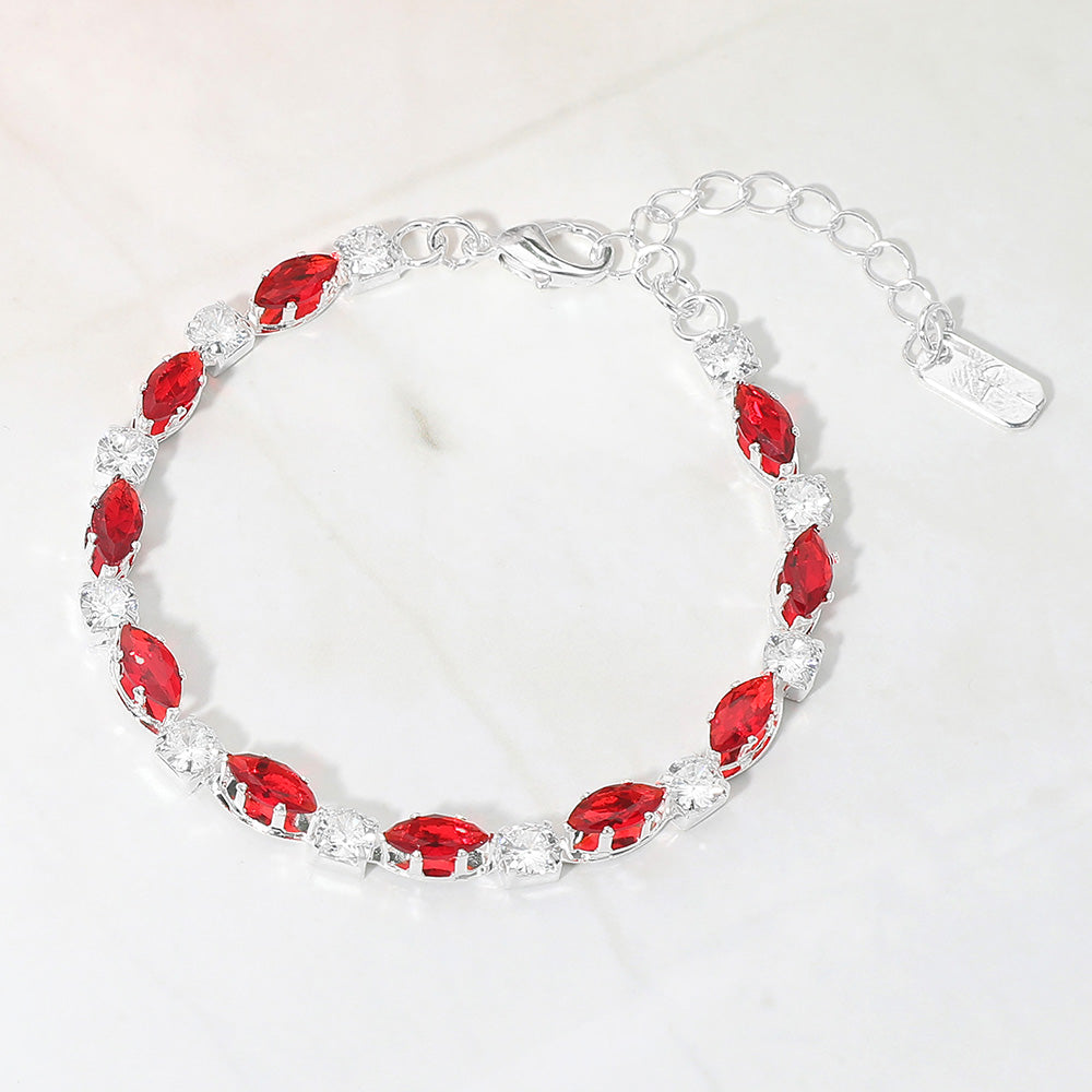Red marquise crystal prom bracelet on silver on white marble background