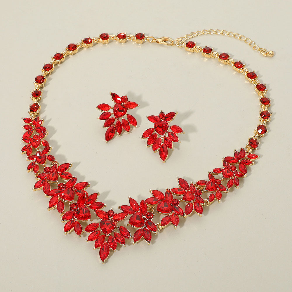 Red marquise floral statement necklace set on gold on a beige background