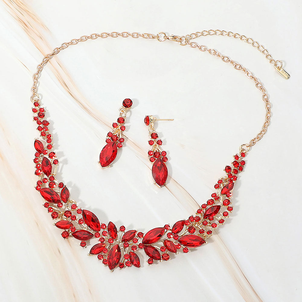Red marquise stone cluster prom and evening necklace set on gold on white marble background