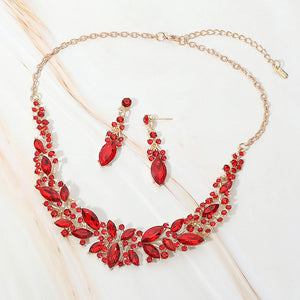 Red marquise stone cluster prom and evening necklace set on gold on white marble background