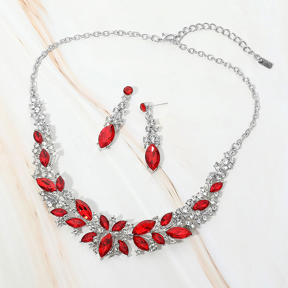 Red and clear marquise stone cluster prom and evening necklace set on silver on white marble background