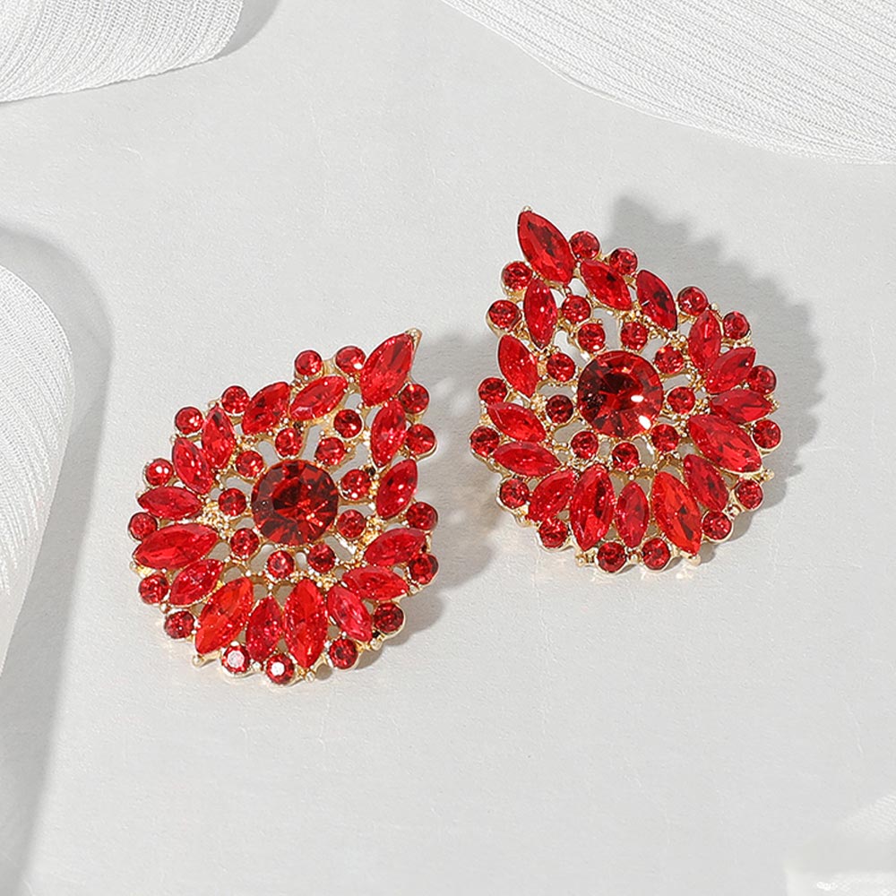 Red marquise stone cluster teardrop earrings on gold on a white background