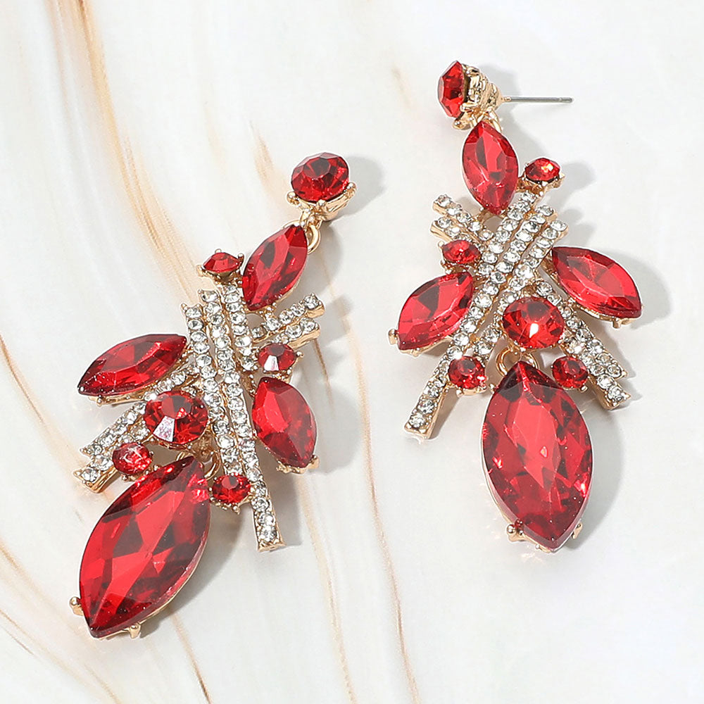 Red marquise stone and rhinestone cluster drop earrings on gold on white marble background