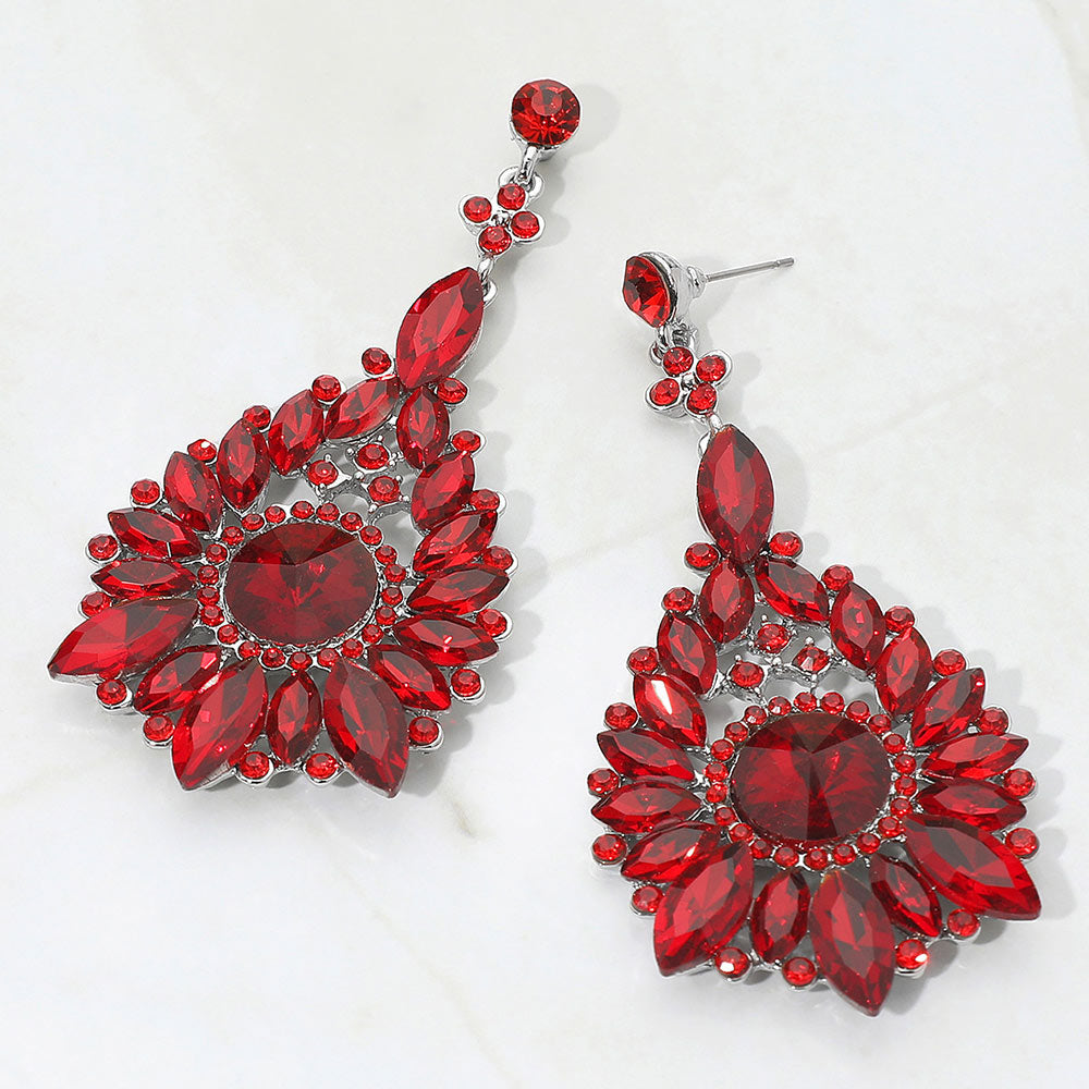 Red marquise and round teardrop statement earrings for prom or pageant evening style on a white background