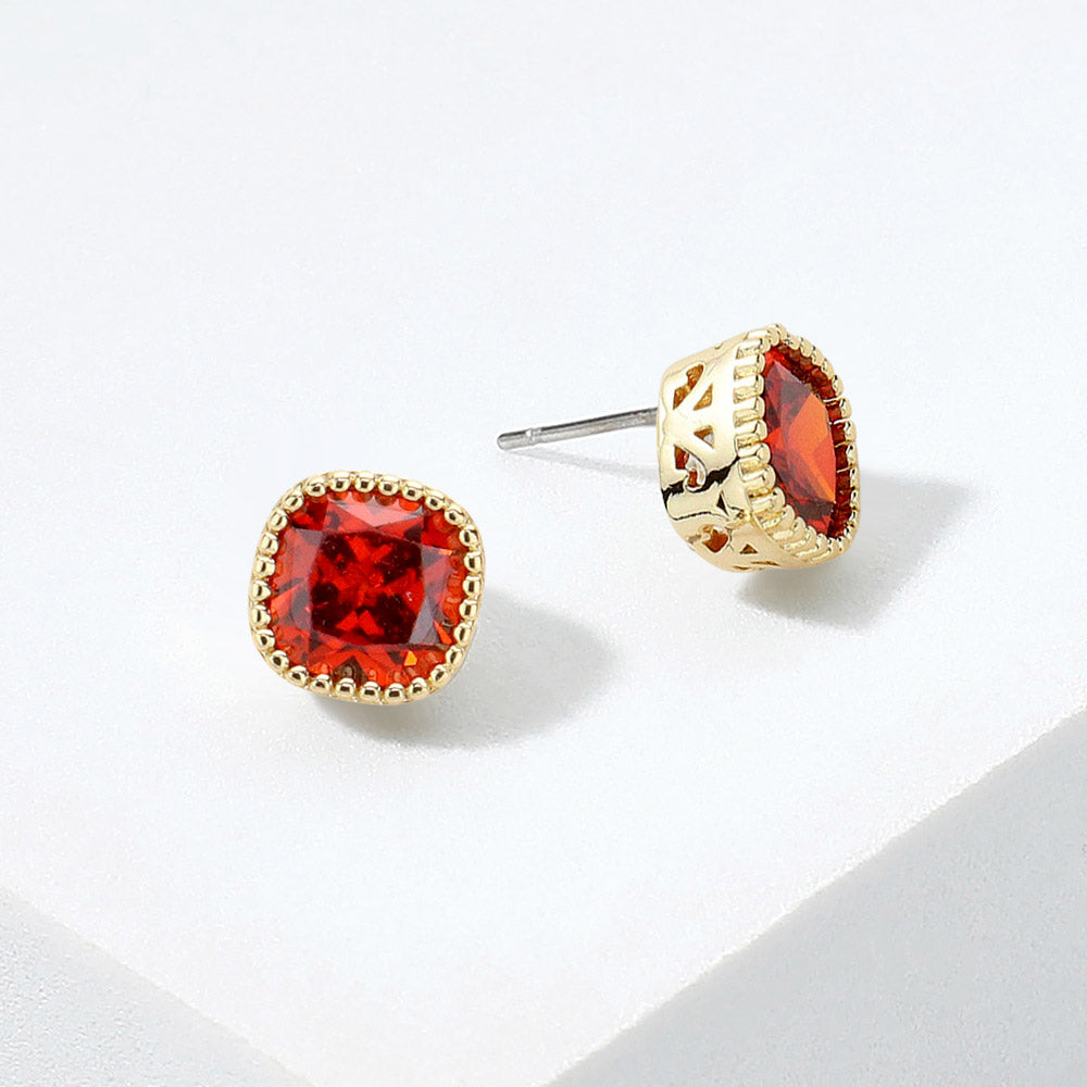Red square CZ stud earrings on gold displayed on white background