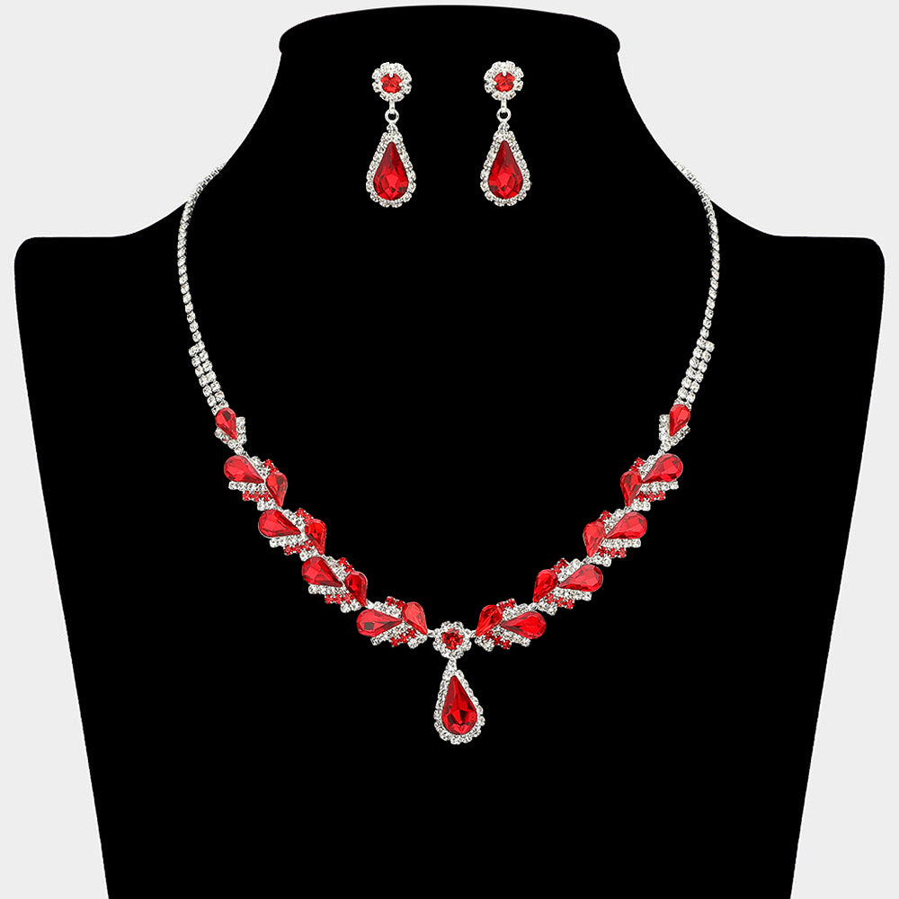 Red marquise pendant necklace set on silver with matching earrings for prom and evening wear on a black mannequin bust on a white background.