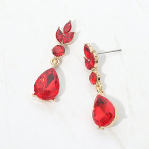 Red crystal teardrop earrings on gold with large pear-shaped bottom crystals and smaller marquise and round crystal accents, displayed on a white background.
