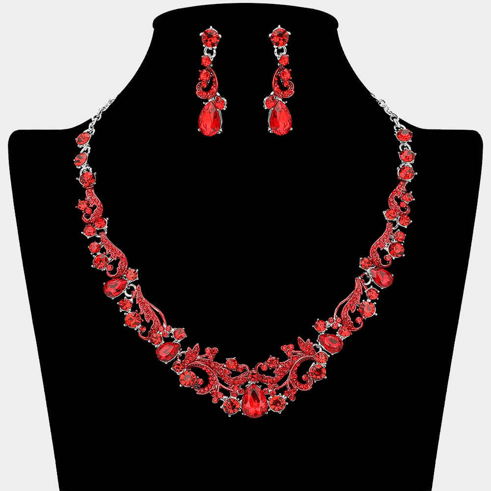 Red teardrop rhinestone cluster necklace set on silver with matching earrings for prom and formal wear. Shown here on a black mannequin bust.