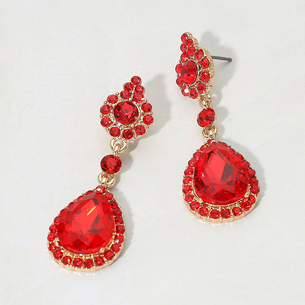 Red teardrop vintage crystal drop formal and evening earrings on gold on white background